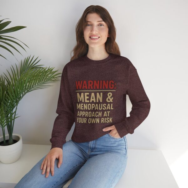 “Warning: Mean and Menopausal – Approach at Your Own Risk” sweatshirt, a cozy and funny statement piece for women embracing perimenopause with humor and attitude.