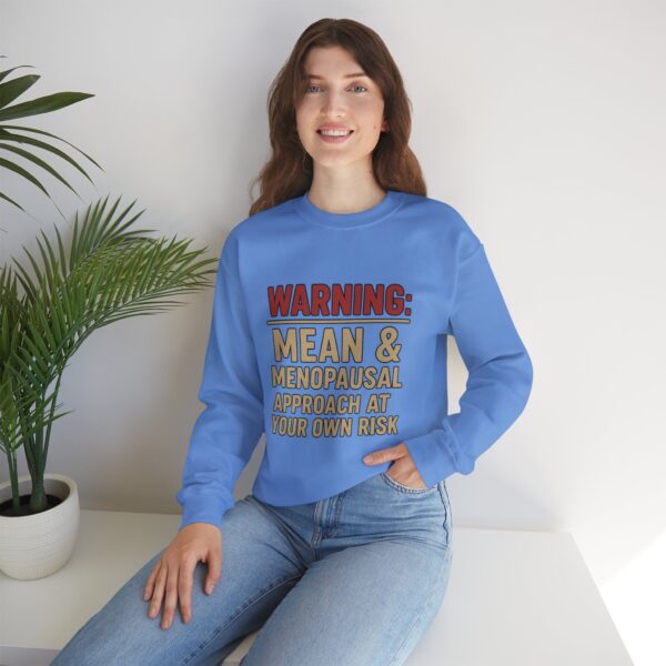 “Warning: Mean and Menopausal – Approach at Your Own Risk” sweatshirt, a cozy and funny statement piece for women embracing perimenopause with humor and attitude.
