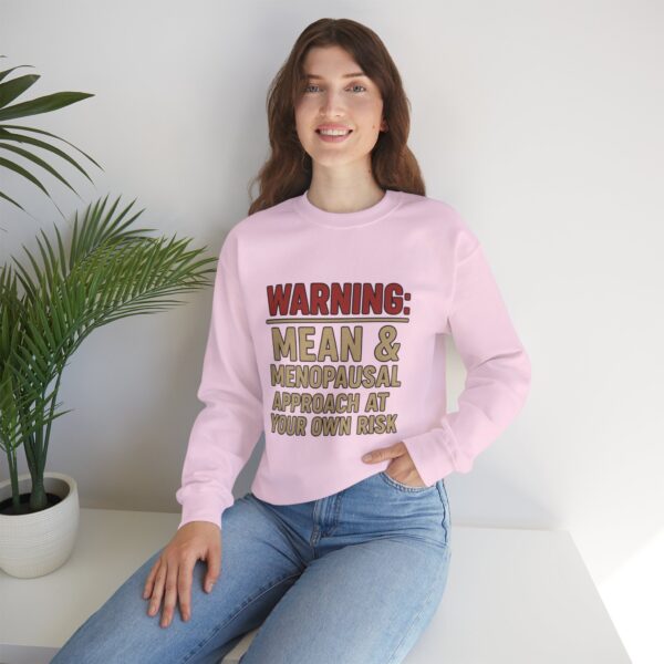 “Warning: Mean and Menopausal – Approach at Your Own Risk” sweatshirt, a cozy and funny statement piece for women embracing perimenopause with humor and attitude.