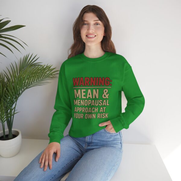 “Warning: Mean and Menopausal – Approach at Your Own Risk” sweatshirt, a cozy and funny statement piece for women embracing perimenopause with humor and attitude.
