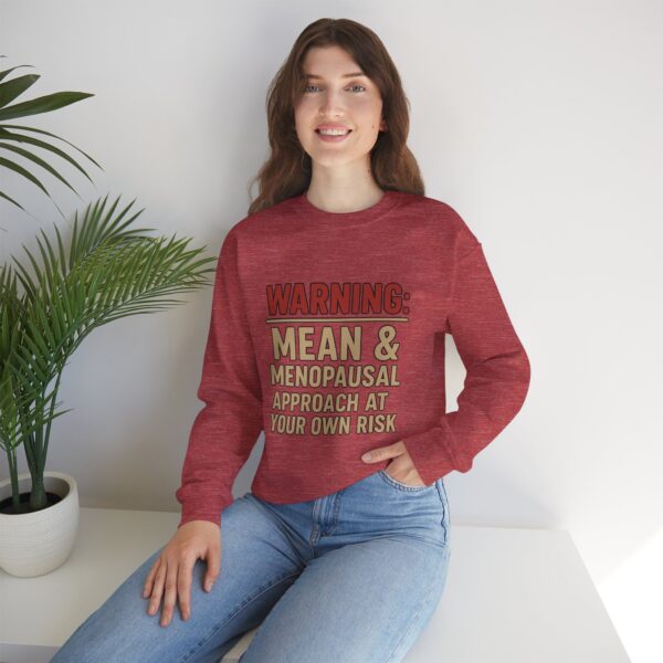 “Warning: Mean and Menopausal – Approach at Your Own Risk” sweatshirt, a cozy and funny statement piece for women embracing perimenopause with humor and attitude.