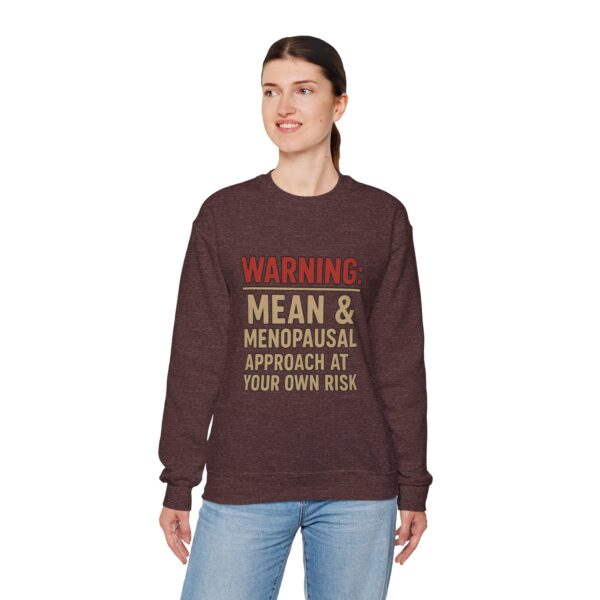 “Warning: Mean and Menopausal – Approach at Your Own Risk” sweatshirt, a cozy and funny statement piece for women embracing perimenopause with humor and attitude.