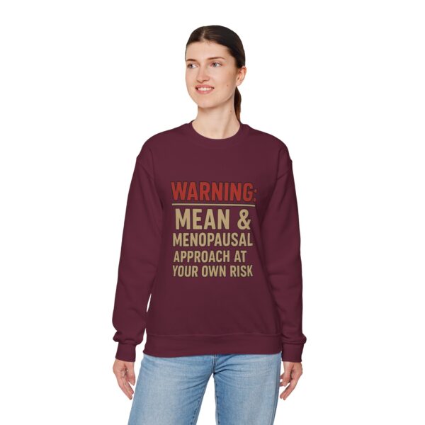 “Warning: Mean and Menopausal – Approach at Your Own Risk” sweatshirt, a cozy and funny statement piece for women embracing perimenopause with humor and attitude.