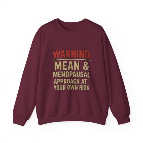 “Warning: Mean and Menopausal – Approach at Your Own Risk” sweatshirt, a cozy and funny statement piece for women embracing perimenopause with humor and attitude.