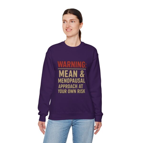 “Warning: Mean and Menopausal – Approach at Your Own Risk” sweatshirt, a cozy and funny statement piece for women embracing perimenopause with humor and attitude.