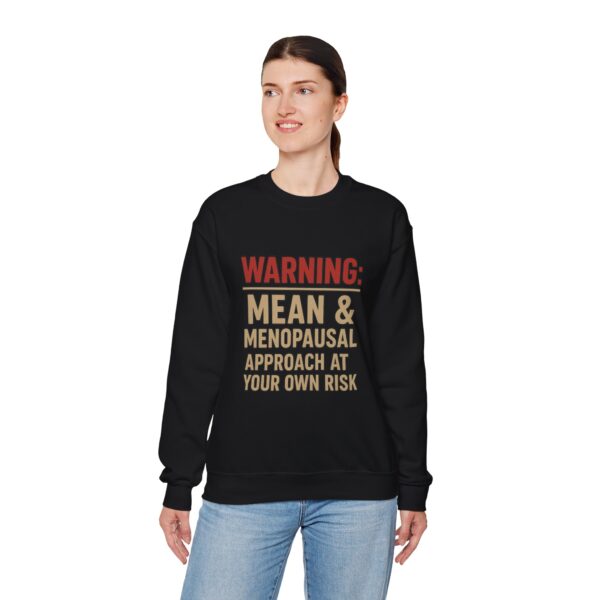 “Warning: Mean and Menopausal – Approach at Your Own Risk” sweatshirt, a cozy and funny statement piece for women embracing perimenopause with humor and attitude.