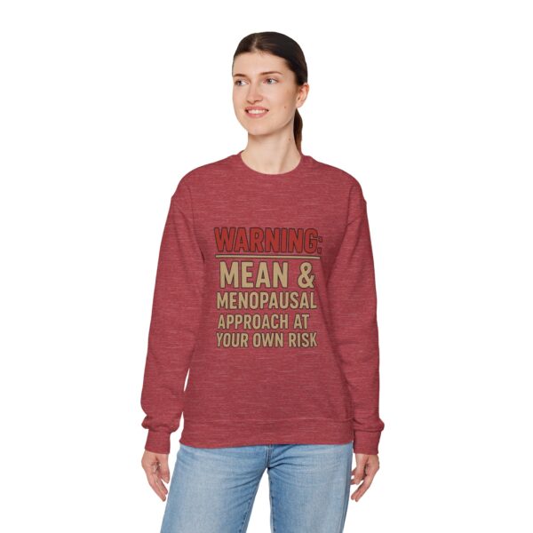 “Warning: Mean and Menopausal – Approach at Your Own Risk” sweatshirt, a cozy and funny statement piece for women embracing perimenopause with humor and attitude.