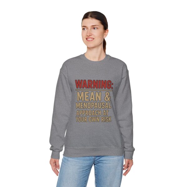 “Warning: Mean and Menopausal – Approach at Your Own Risk” sweatshirt, a cozy and funny statement piece for women embracing perimenopause with humor and attitude.