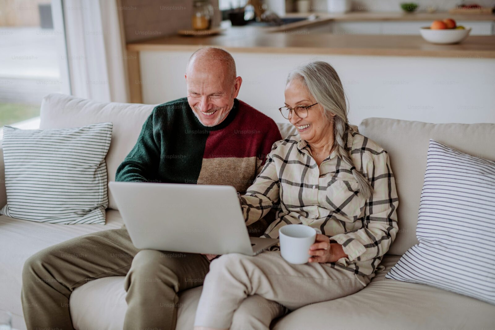 “Middle-aged couple using a computer — A Man’s Guide to Menopause featured image symbolizing learning and support through menopause.”